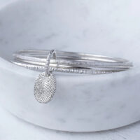 A photo of the KS03 - Triple Hammered Bangle With Fingerprint Charm Memorial from G. Seller